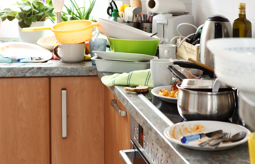 a kitchen counter full of dirty dishes.